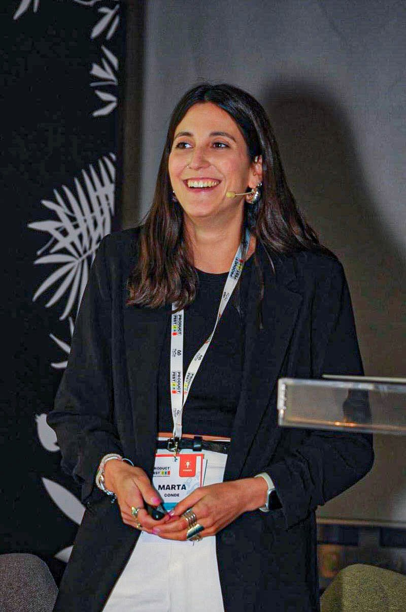 Marta Conde speaking on stage